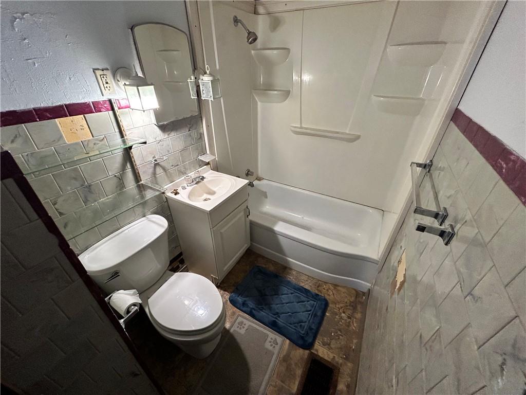 1347 High Road Clairton, PA 15025 - Photo 13 of 21 a white toilet sitting next to a bathroom sink