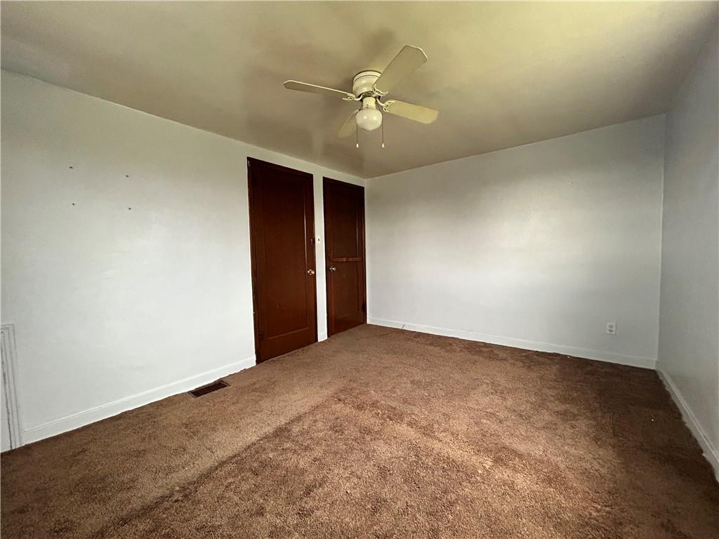 1347 High Road Clairton, PA 15025 - Photo 10 of 21 an empty room with a ceiling fan and a window