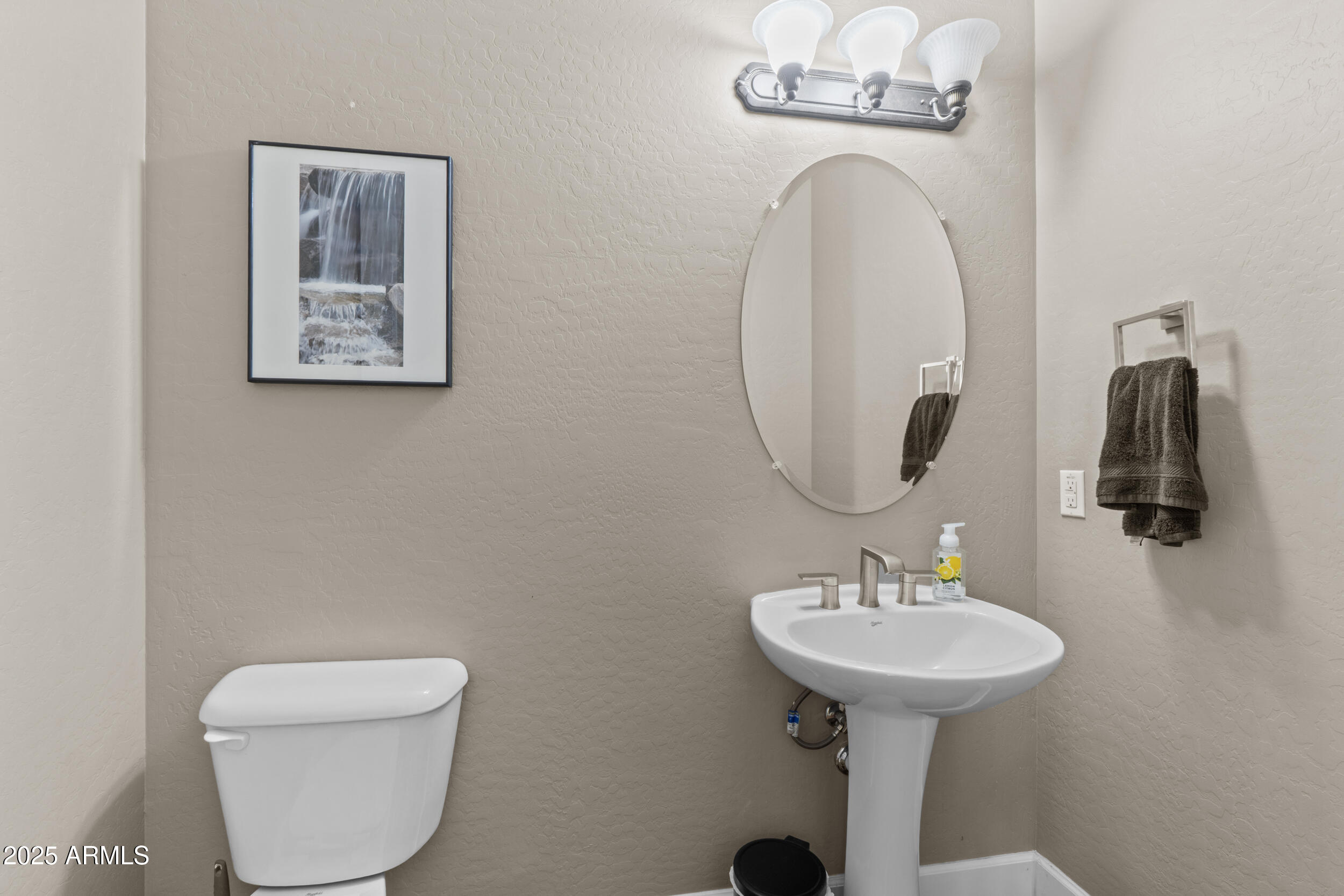 2879 East Janelle Way Gilbert, AZ 85298 - Photo 8 of 33 a bathroom with a toilet sink and mirror