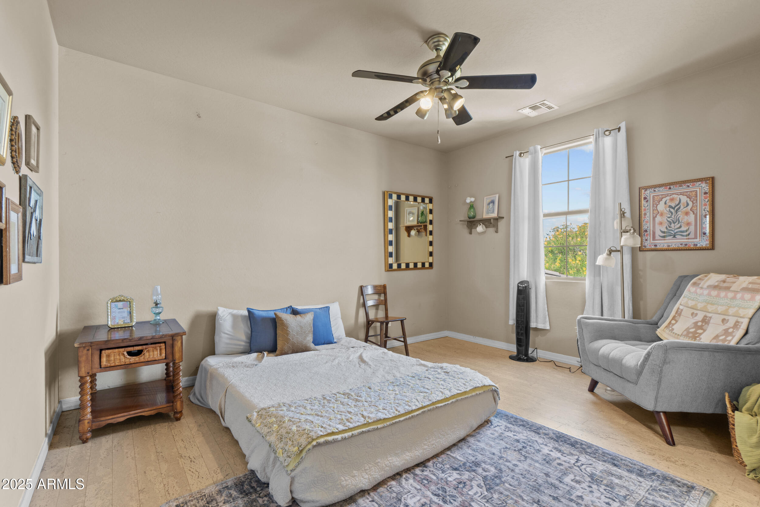 2879 East Janelle Way Gilbert, AZ 85298 - Photo 12 of 33 a bedroom with a bed a couch and paintings on the wall