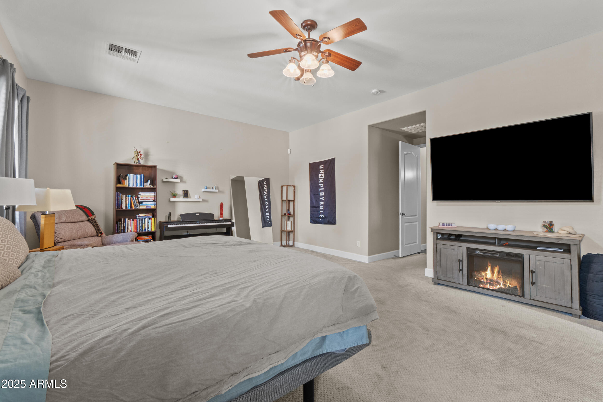 2879 East Janelle Way Gilbert, AZ 85298 - Photo 16 of 33 a bedroom with a bed and a flat screen tv