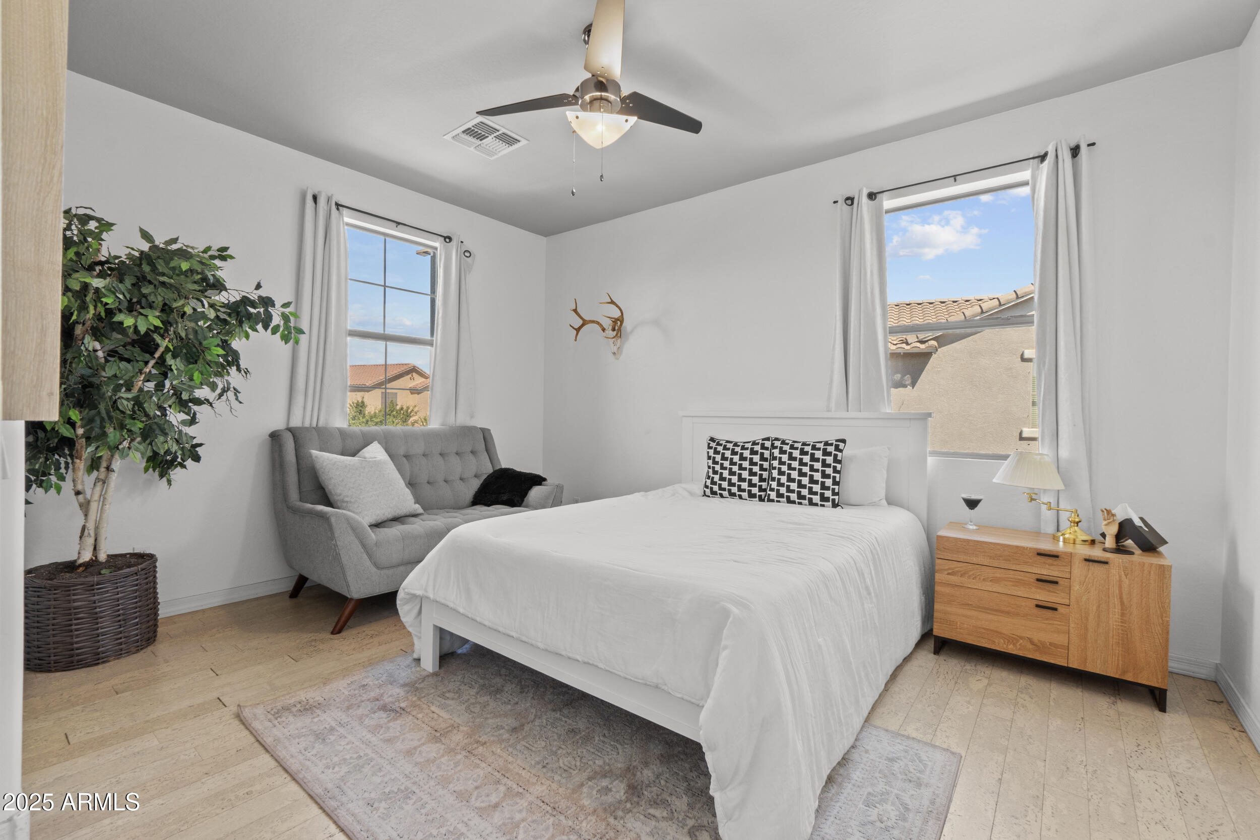 2879 East Janelle Way Gilbert, AZ 85298 - Photo 17 of 33 a bedroom with a bed and a potted plant