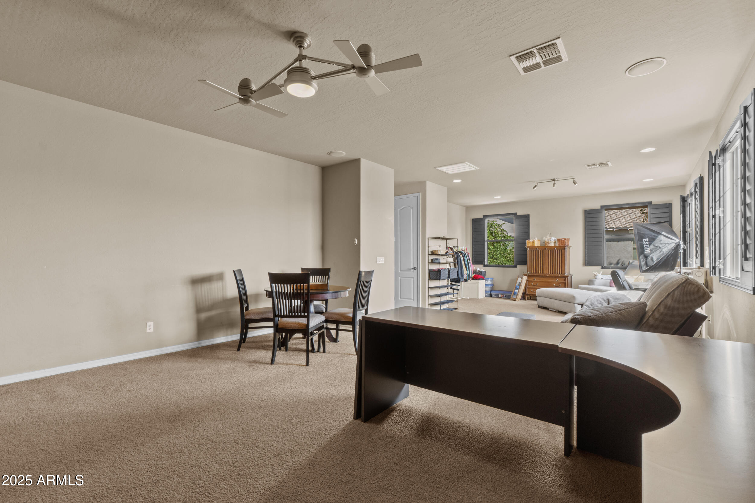 2879 East Janelle Way Gilbert, AZ 85298 - Photo 21 of 33 a dining room with furniture and a chandelier fan
