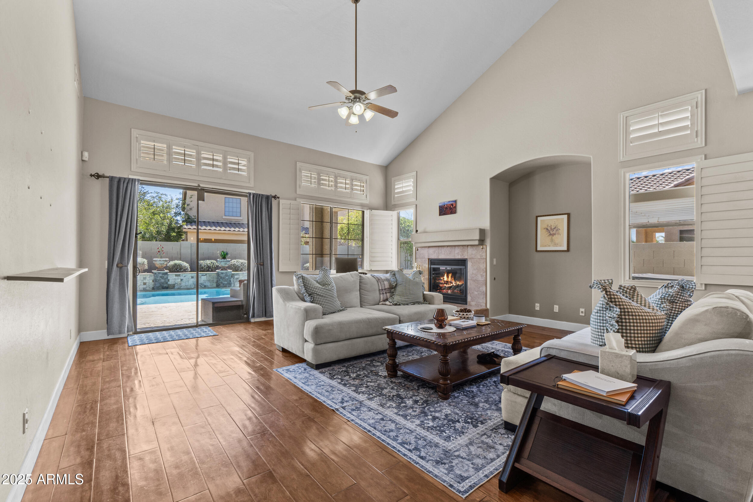 2879 East Janelle Way Gilbert, AZ 85298 - Photo 2 of 33 a living room with fireplace furniture and a large window