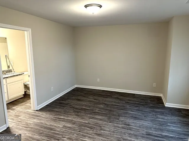 a view of a room with wooden floor