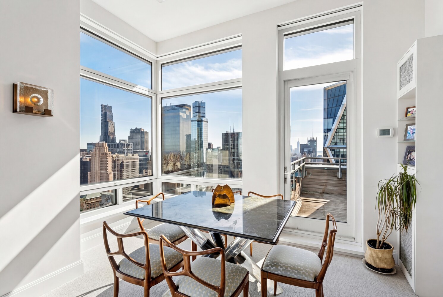 301 West 57th Street, Unit 52C Manhattan, NY 10019 - Photo 5 of 13 a dining room with furniture and a potted plant