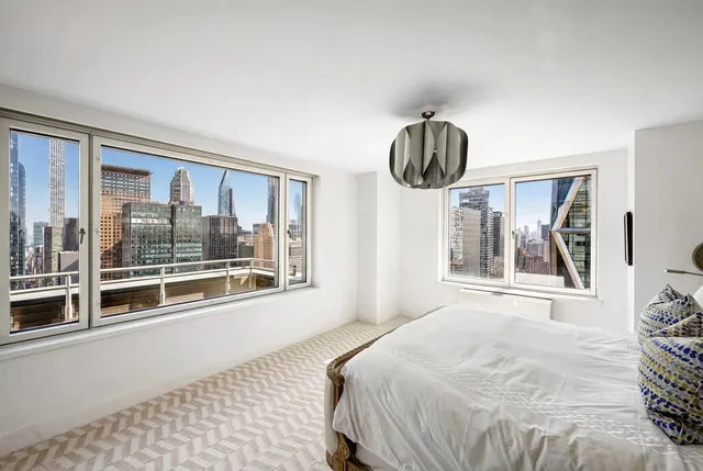 a bedroom with a large bed and a large window