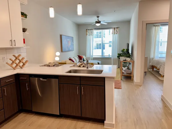 a kitchen with a sink cabinets and wooden floor