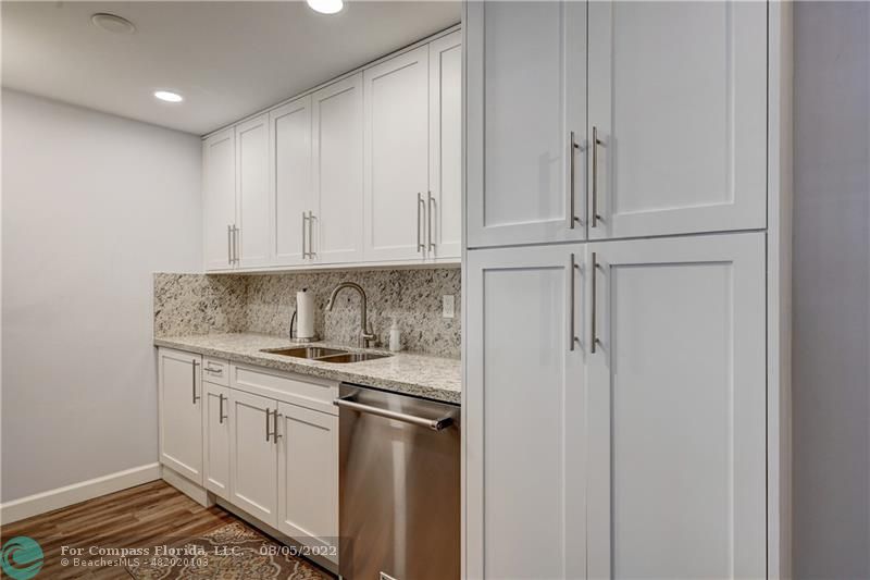 a view of a kitchen with white cabinets