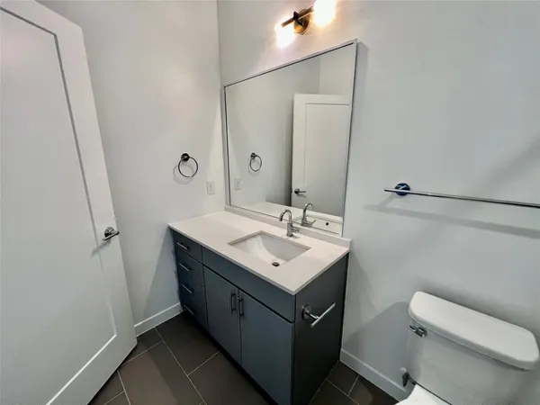 a bathroom with a sink toilet and mirror