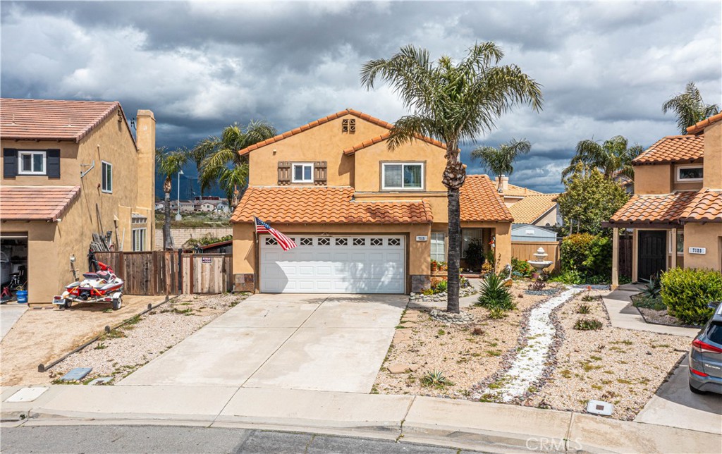 a view of multiple houses with cars parked