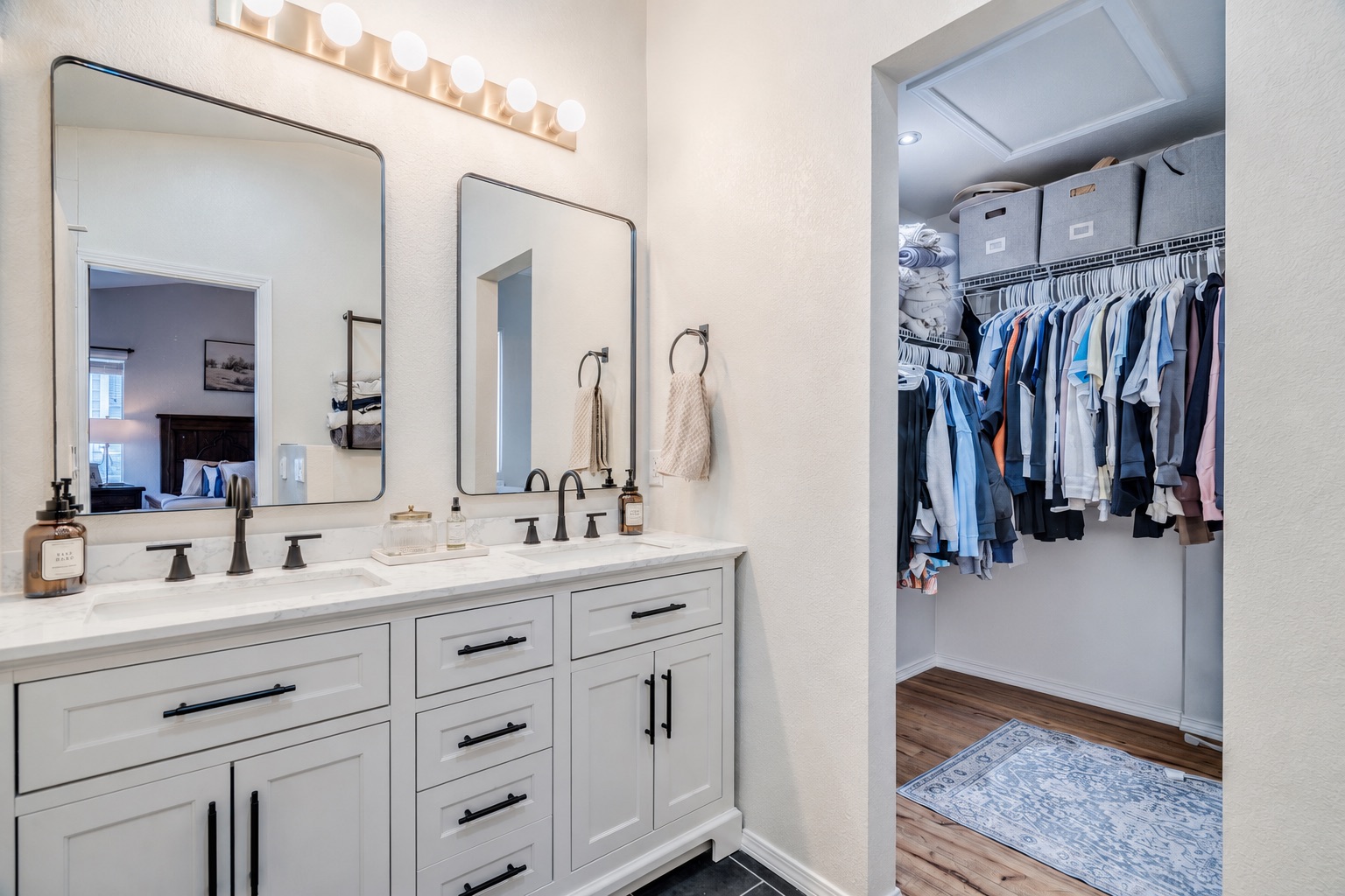 175 Wetzel Kyle, TX 78640 - Photo 4 of 27 Double vanities with ample storage lead into a spacious, organized walk-in closet.