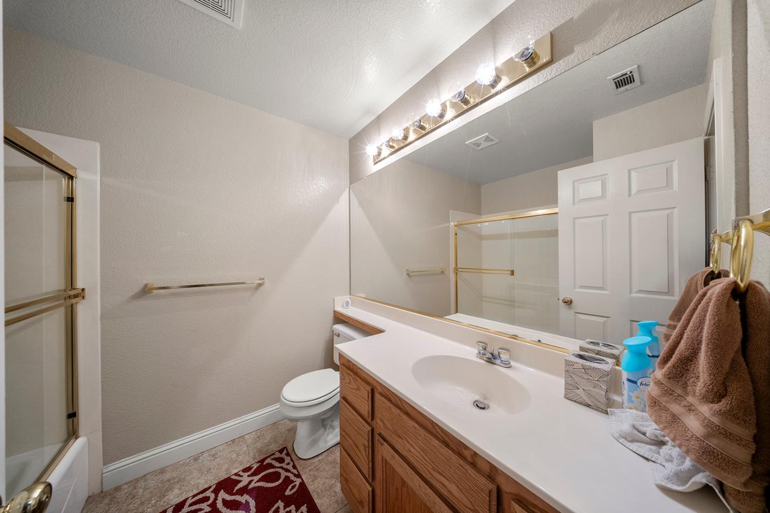 1837 Brookside Drive Manteca, CA 95336 - Photo 21 of 36 a bathroom with a sink a toilet and shower