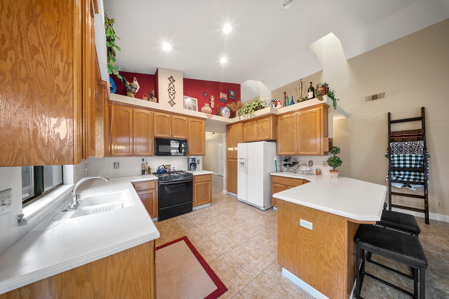 1837 Brookside Drive Manteca, CA 95336 - Photo 4 of 36 a kitchen with stainless steel appliances granite countertop a sink stove and refrigerator