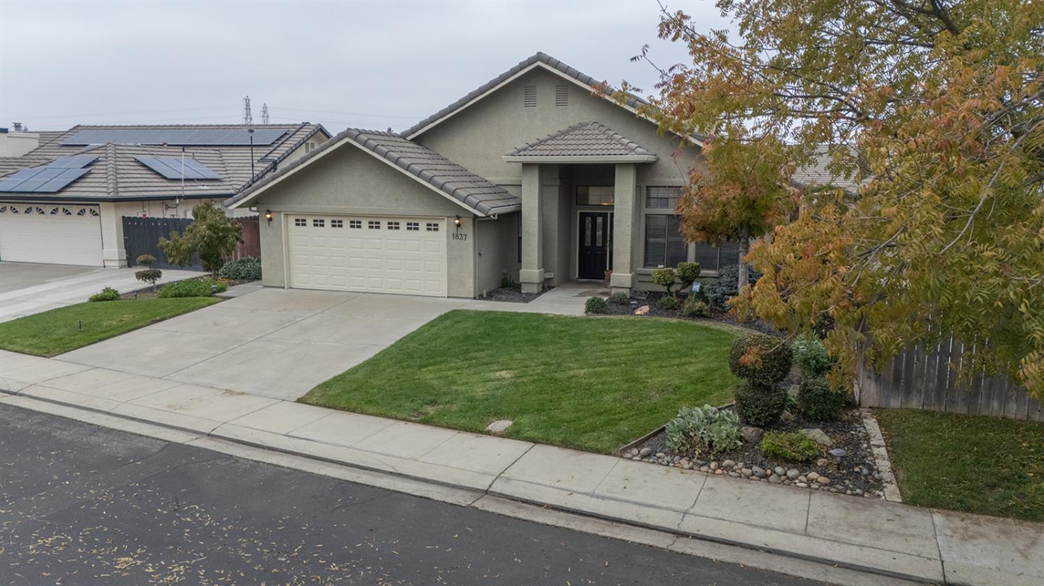 1837 Brookside Drive Manteca, CA 95336 - Photo 6 of 36 a view of a house with a yard and garage