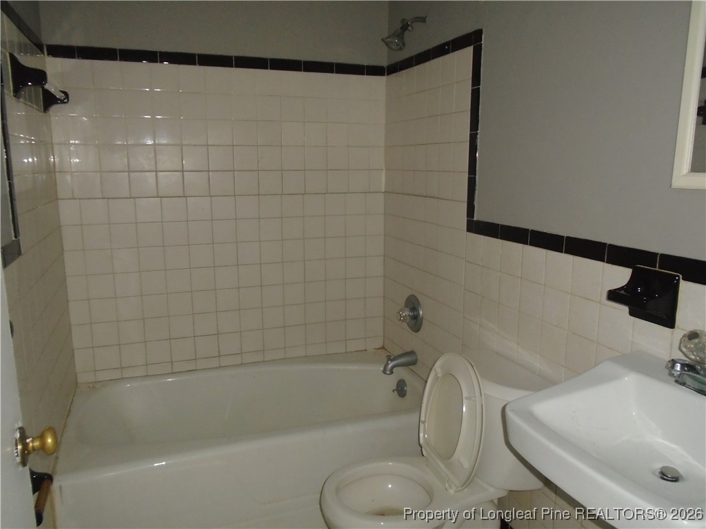 611 Drypoint Lane, Unit 1 Hope Mills, NC 28348 - Photo 12 of 15 a bathroom with a sink and a mirror