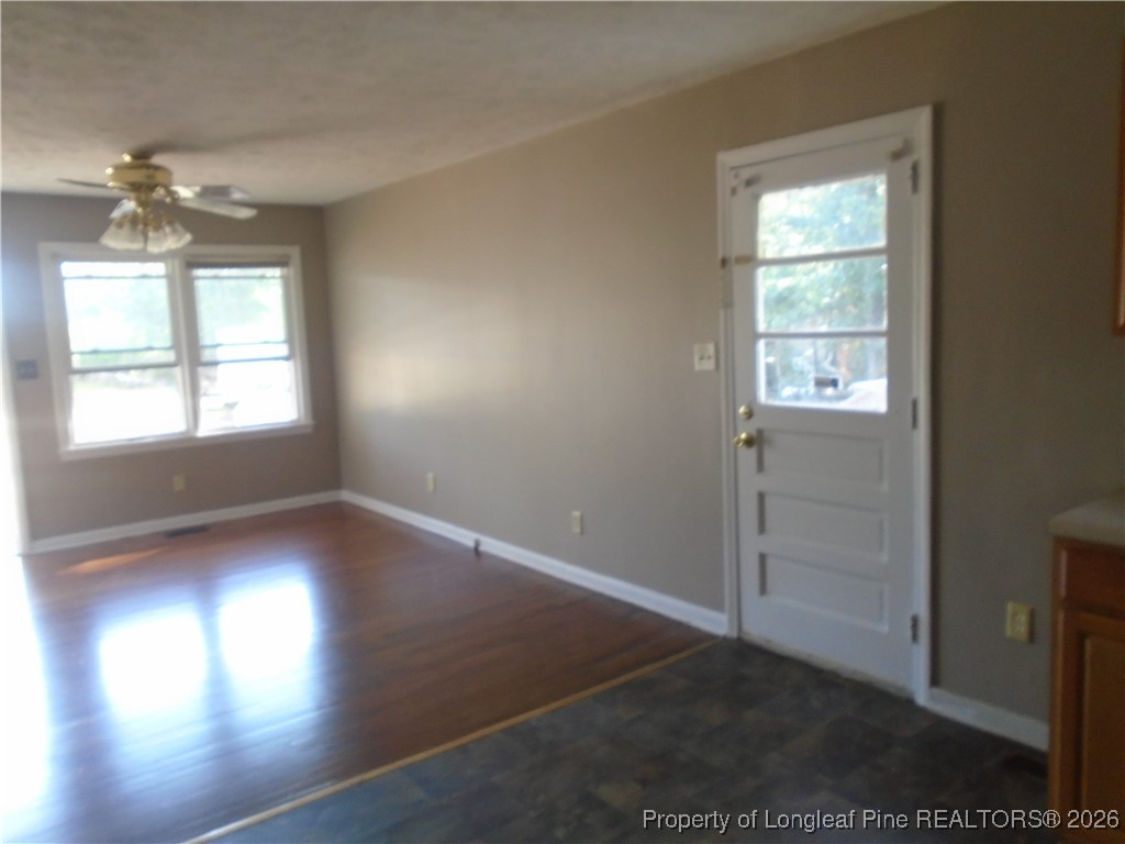 611 Drypoint Lane, Unit 1 Hope Mills, NC 28348 - Photo 8 of 15 an empty room with wooden floor and windows