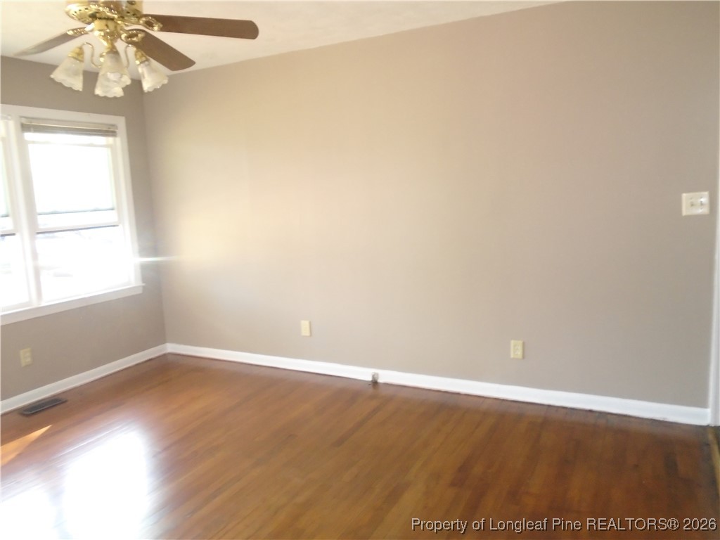 611 Drypoint Lane, Unit 1 Hope Mills, NC 28348 - Photo 9 of 15 an empty room with wooden floor and windows