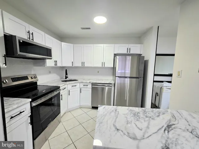 a kitchen with a sink stove and refrigerator