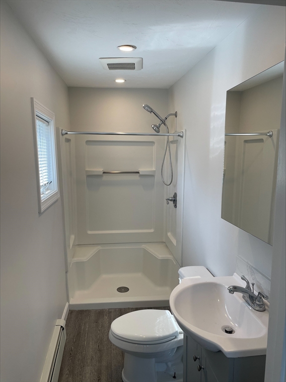 50 Main Street, Unit 3 Woburn, MA 01801 - Photo 5 of 8 a bathroom with a sink a toilet and shower