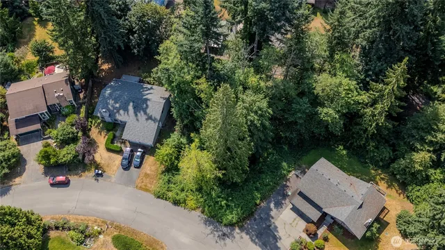 an aerial view of a house with a yard and garden