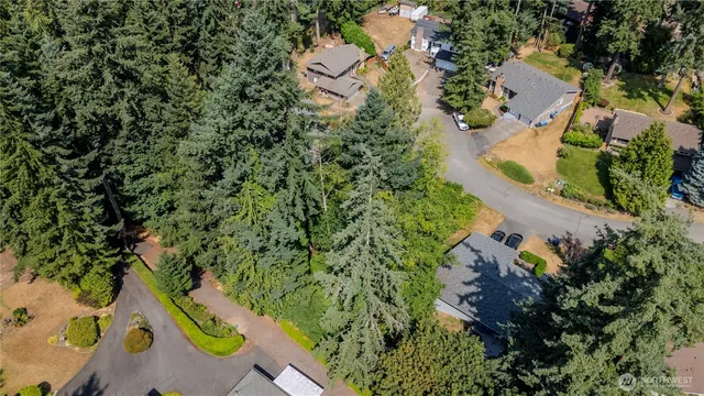 an aerial view of a house with a yard and lake view