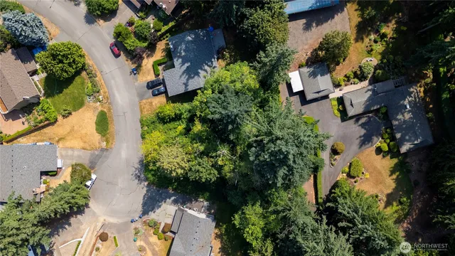 an aerial view of a house with a yard and garden