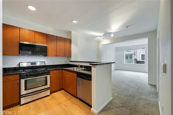 a kitchen with stainless steel appliances granite countertop a sink and cabinets