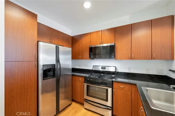 a view of a kitchen with a sink and cabinet