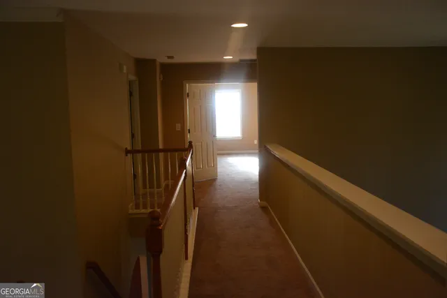 a kitchen with granite countertop white cabinets and black appliances