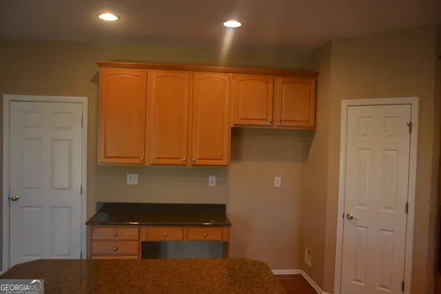 a bathroom with a tub sink vanity and mirror