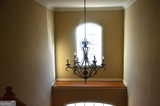 a view of empty room with windows and fan