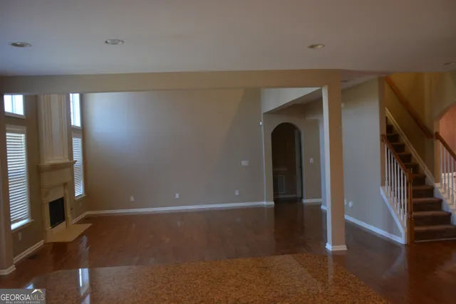 a view of room with window and wooden floor