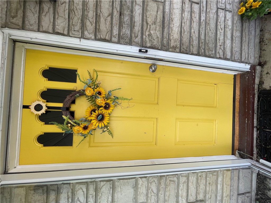 360 Ridge Street Piqua, OH 45356 - Photo 3 of 46 A vibrant yellow front door creates a welcoming entryway.