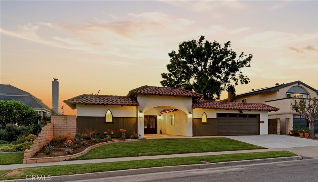 13601 Carroll Way Tustin, CA 92780 - Photo 1 of 28 a front view of a house with a garden