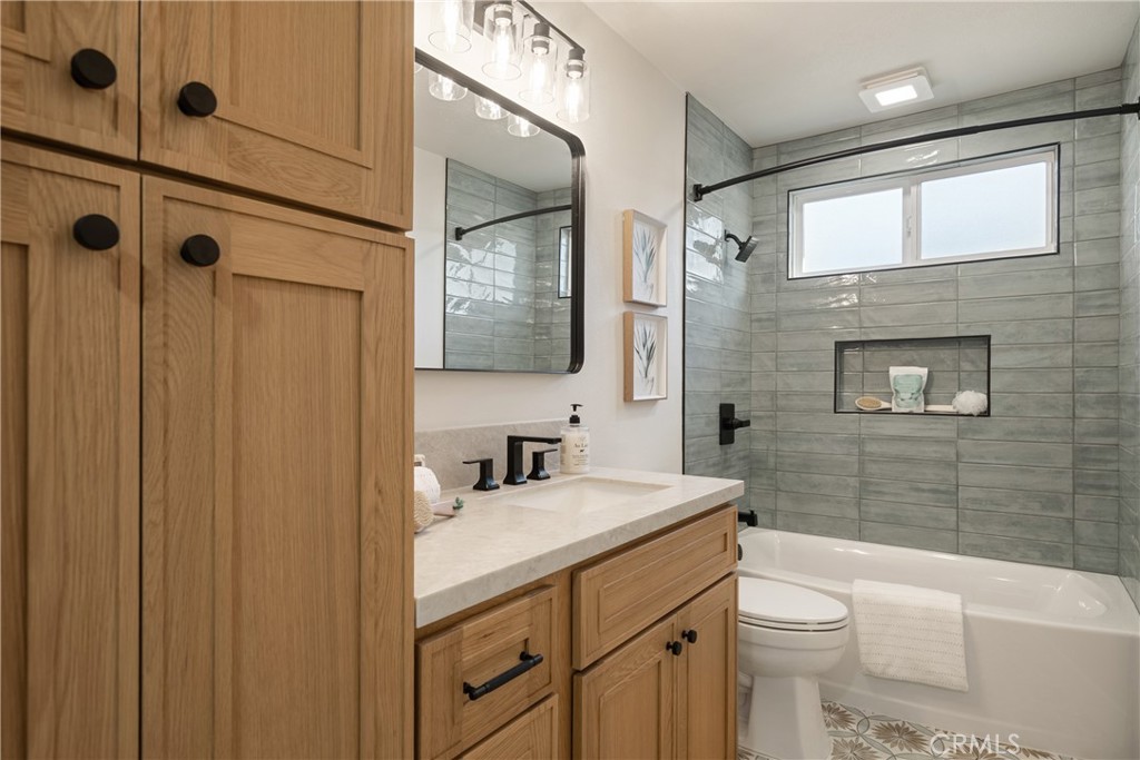 13601 Carroll Way Tustin, CA 92780 - Photo 13 of 28 a bathroom with a granite countertop sink toilet and shower