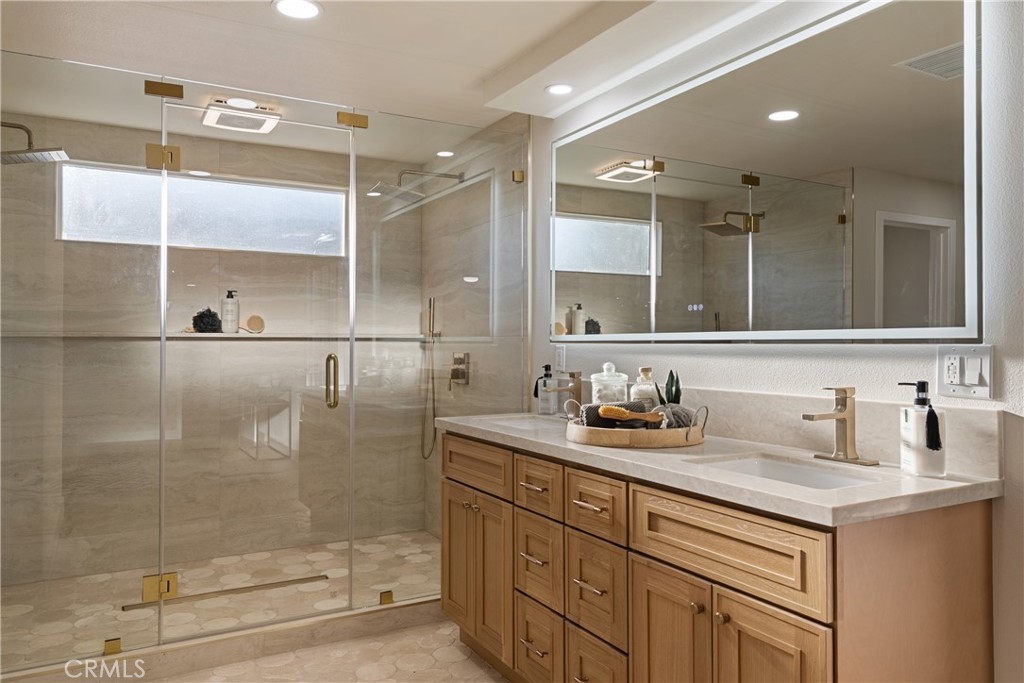 13601 Carroll Way Tustin, CA 92780 - Photo 21 of 28 a bathroom with a sink and a mirror