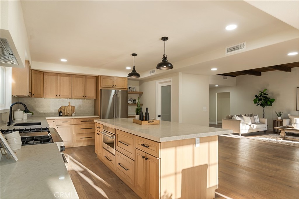 13601 Carroll Way Tustin, CA 92780 - Photo 6 of 28 a kitchen with a sink stove and wooden floor