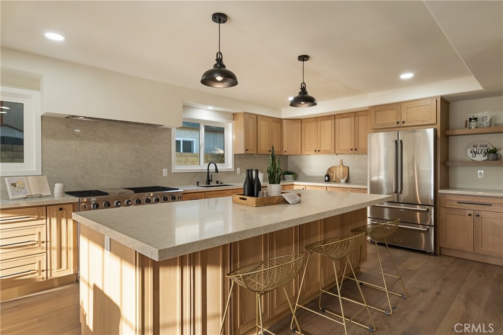 13601 Carroll Way Tustin, CA 92780 - Photo 8 of 28 a very nice looking kitchen with a center island wooden floor and stainless steel appliances
