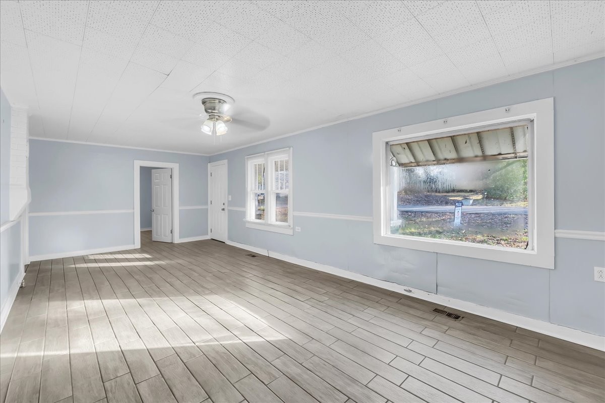 807 Perrigan Lane Manchester, TN 37355 - Photo 11 of 44 a view of an empty room with wooden floor and a window
