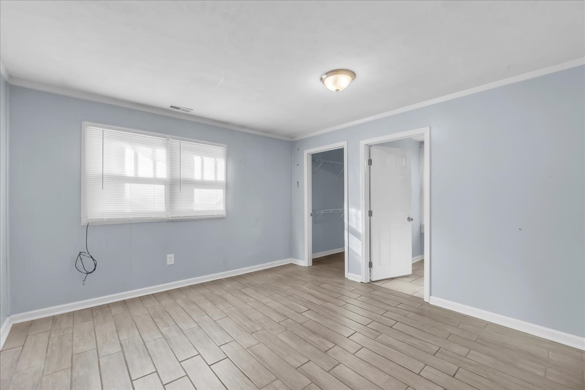 807 Perrigan Lane Manchester, TN 37355 - Photo 15 of 44 a view of an empty room with wooden floor and a window