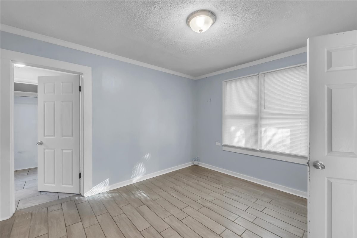807 Perrigan Lane Manchester, TN 37355 - Photo 19 of 44 an empty room with wooden floor and windows