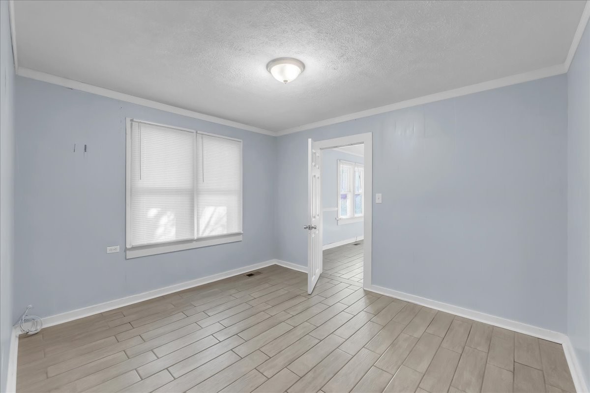 807 Perrigan Lane Manchester, TN 37355 - Photo 20 of 44 an empty room with wooden floor and windows