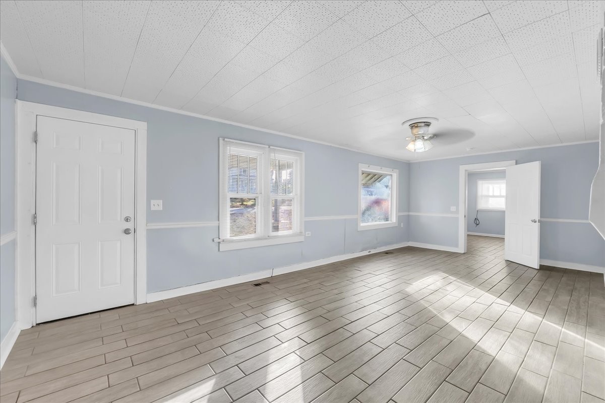 807 Perrigan Lane Manchester, TN 37355 - Photo 10 of 44 an empty room with wooden floor and windows