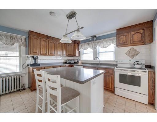 15 Great Road Stow, MA 01775 - Photo 3 of 24 a kitchen with stainless steel appliances granite countertop a stove a sink dishwasher and white cabinets with wooden floor