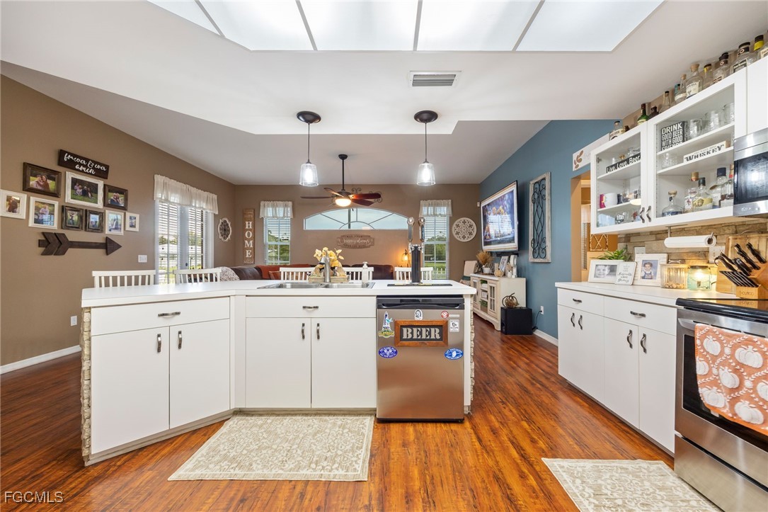 914 Sawgrass Street Clewiston, FL 33440 - Photo 12 of 43 a kitchen with cabinets and wooden floor