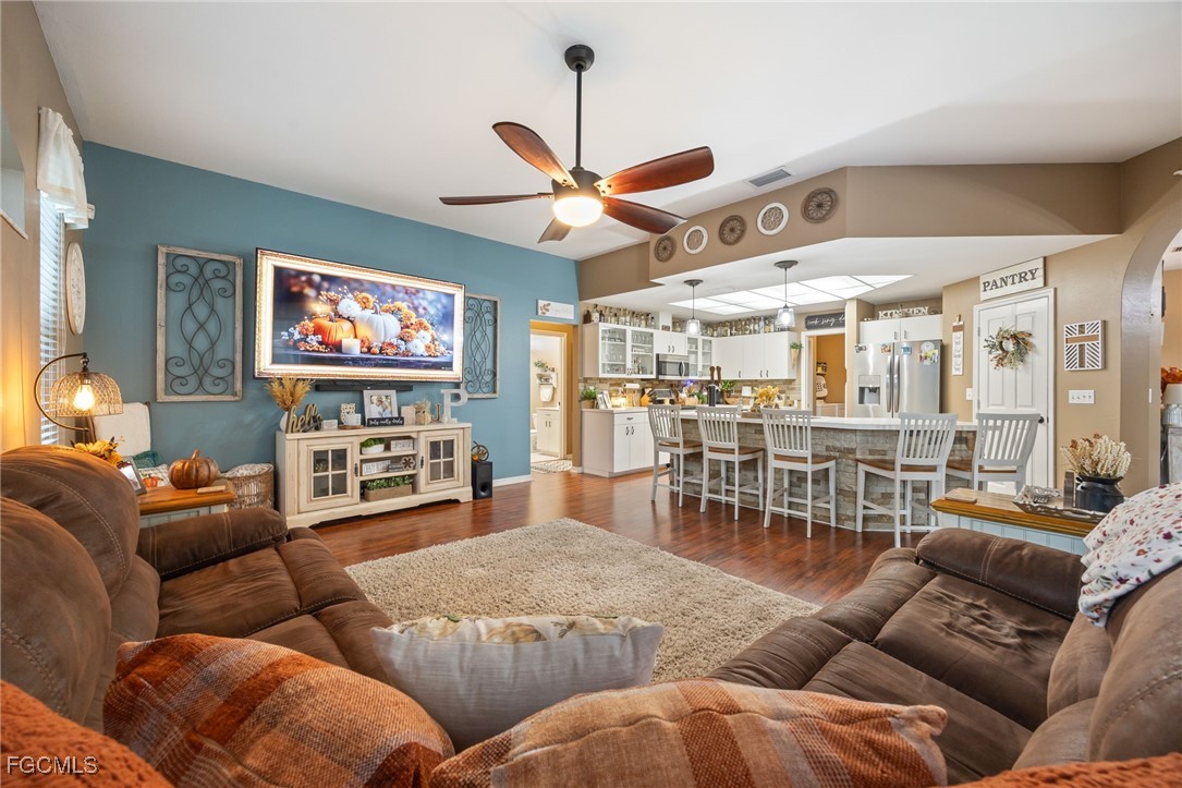 914 Sawgrass Street Clewiston, FL 33440 - Photo 17 of 43 a living room with furniture a ceiling fan and a flat screen tv