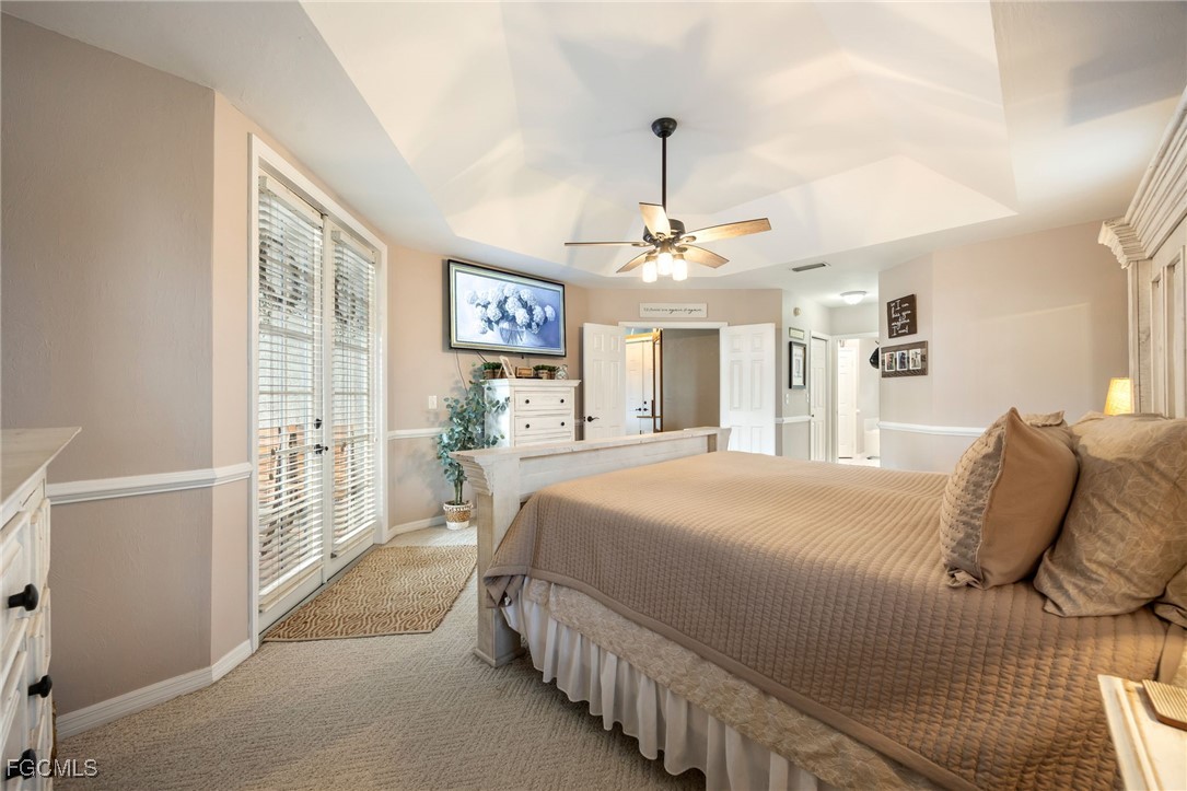 914 Sawgrass Street Clewiston, FL 33440 - Photo 19 of 43 a spacious bedroom with a bed and a chandelier