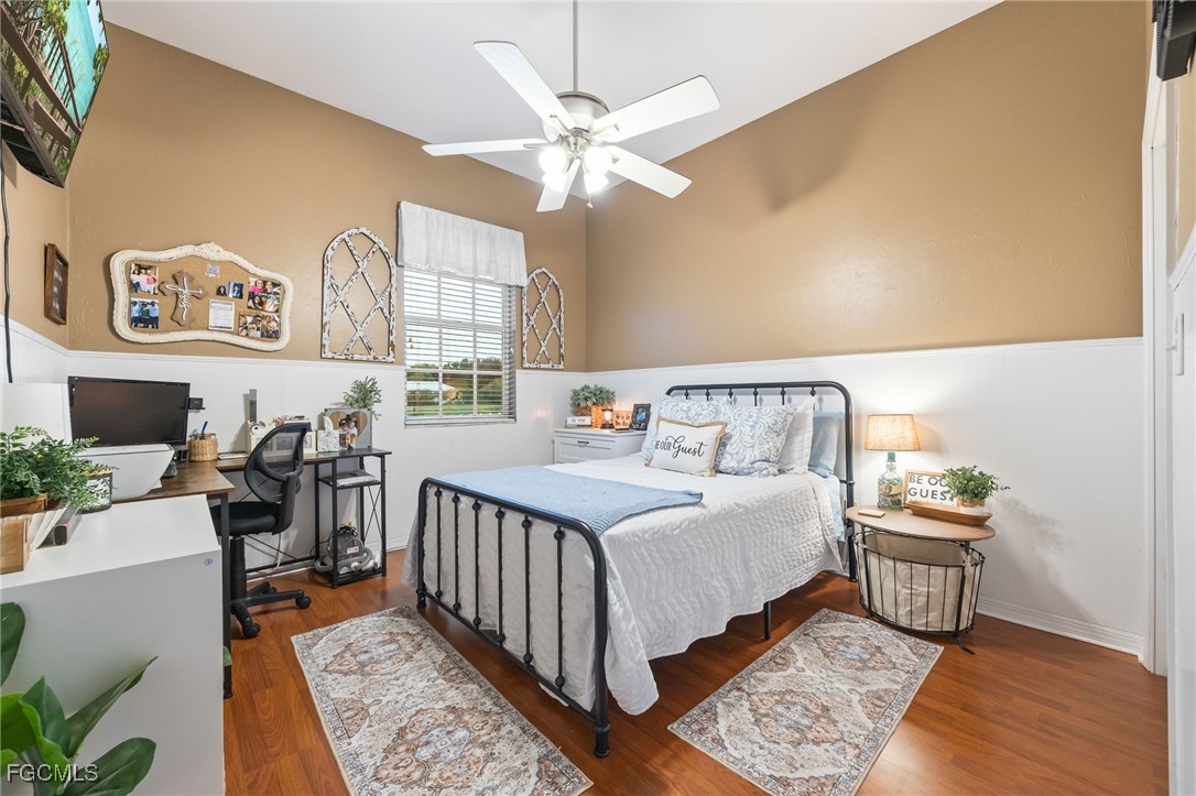 914 Sawgrass Street Clewiston, FL 33440 - Photo 23 of 43 a bedroom with a bed and a chandelier