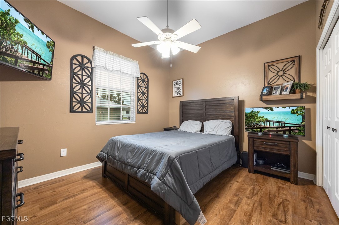 914 Sawgrass Street Clewiston, FL 33440 - Photo 25 of 43 a bedroom with a bed and a chandelier